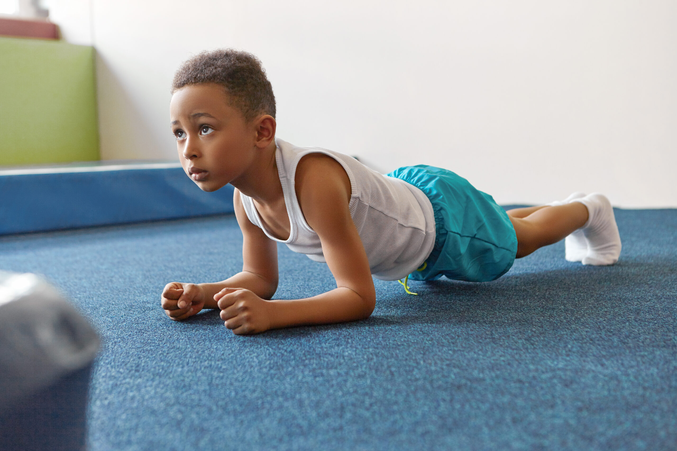 Self determined African American boy dressed in sports clothes p